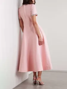 Elegant pink A-line midi dress featuring a rhinestone embellished neckline and cuffs