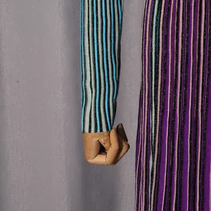 Detailed close-up showing the texture of a colorful vertical striped knit dress fabric.