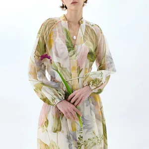 Close-up of elegant floral print on a long dress with V-neck and puff sleeves