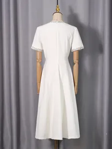 Elegant white midi dress with rhinestone neckline and short sleeves shown from the back