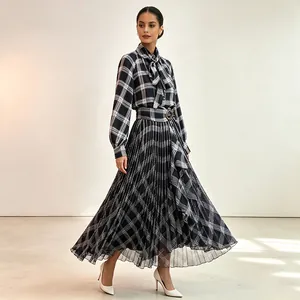 Elegant plaid two-piece set with tie-neck blouse and high-waisted pleated maxi skirt for women.