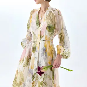Detail of elegant floral puff sleeve maxi dress with V-neck and belted waist