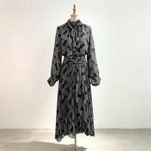 Elegant pleated two-piece set with long-sleeved top and geometric wave print on mannequin