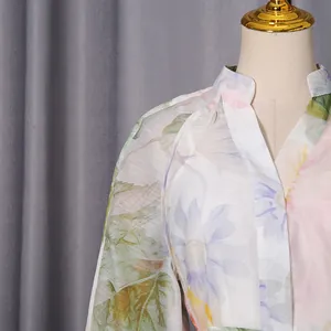 Detailed view of elegant floral print chiffon dress featuring a stylish V-neckline and collar