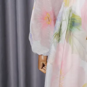Macro detail of soft floral print fabric and elegant puff sleeves on a chic summer gown