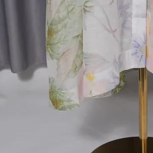 Detailed close-up of the delicate floral print fabric hem on a sweet style long maxi dress
