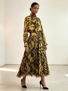 Elegant yellow abstract animal print two-piece set with bow tie blouse and pleated midi skirt