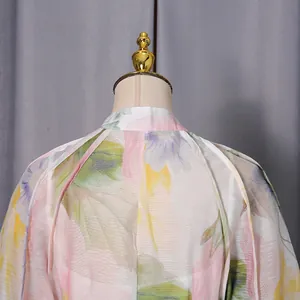 Close-up detail of the floral print maxi dress back neckline showing textured sheer fabric.