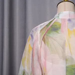 Detail view of the elegant floral print and textured fabric on a sweet long dress.