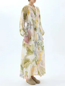 Elegant floral print maxi dress with V-neck and puff sleeves on white studio background