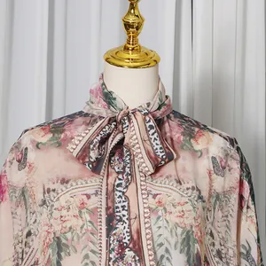 Detail of French style floral print dress with elegant neck tie and leopard pattern.