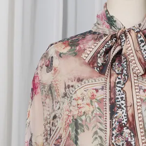 Detail of French vintage floral and leopard print dress with high neck tie and rhinestones.