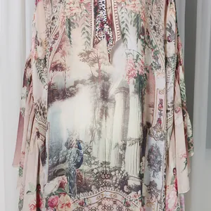 Close-up of French court style floral print with peacock and garden motifs on dress