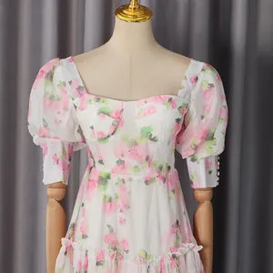 Detailed view of a vintage floral print dress with a sweetheart neck and puff sleeves
