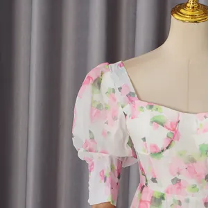Close-up detail of romantic floral print dress featuring puff sleeves and sweetheart neckline