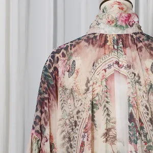 Close-up of elegant high-neck collar and intricate floral leopard print on a French style dress