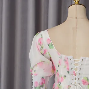 Detailed view of floral dress back featuring elegant lace-up ribbon design and print