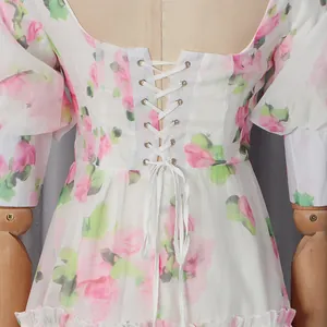 Close-up of romantic floral dress with vintage lace-up back detail and corset waist.