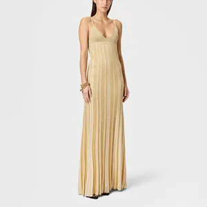 Elegant gold pleated maxi dress with deep V-neck and thin straps for luxury vacation.