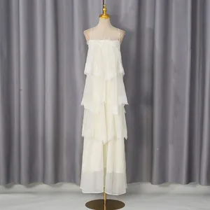 Elegant white tiered lace maxi dress with delicate spaghetti straps and ruffled layers