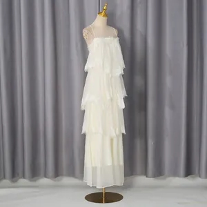 Elegant white tiered lace maxi dress with delicate spaghetti straps and mesh ruffles
