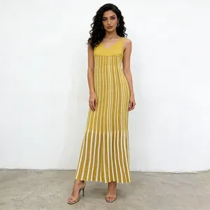 Full-length view of yellow and white vertical striped knit maxi dress on a model