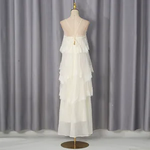 Back view of an elegant cream lace tiered maxi dress on a mannequin