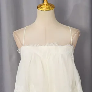 Detail of white lace patchwork trim on sweet style sleeveless camisole long dress.