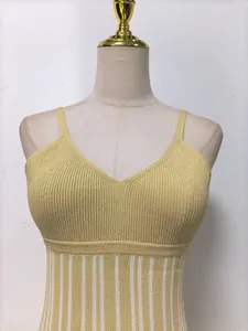 Close-up detail of a gold knitted V-neck camisole dress with fine ribbing texture