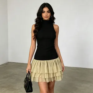 Detailed view of a French style sleeveless high-neck dress with ruffled gold skirt