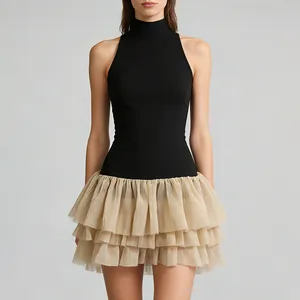 Close-up of sleeveless high-neck mini dress with black top and beige ruffled tulle skirt