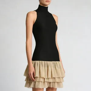 Detailed close-up of a two-tone sleeveless mini dress featuring a ruffled tulle skirt