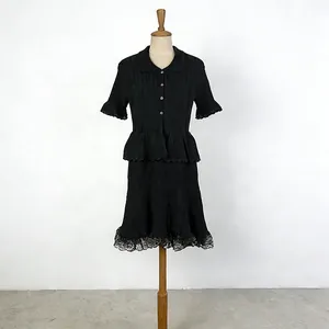 Detailed view of a black French style knit two-piece set displayed on a mannequin.