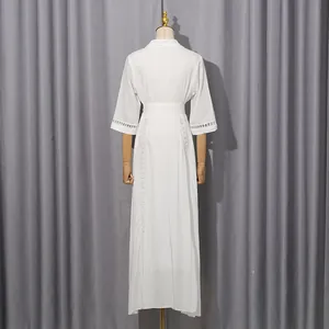 Back view of a white French vintage dress featuring intricate hollow-out lace details