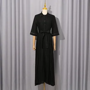 Full view of a French retro black dress featuring hollow-out details and a waist tie.