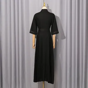 Back view of black maxi dress featuring intricate hollow-out lace detailing on sleeves