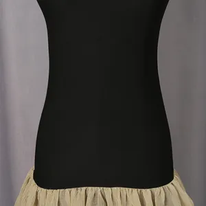 Close-up detail of a French style contrast dress with black bodice and beige ruffled hem