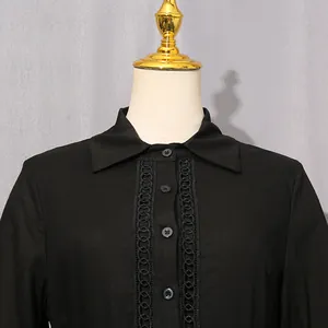 Close-up detail of a French retro black dress with lace hollow-out and button placket