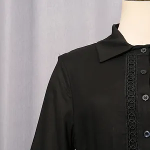 Close-up view of a black French vintage dress with elegant hollow-out lace and buttons