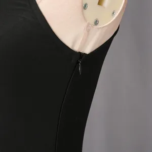 Detailed macro view of a black sleeveless dress showing the invisible side zipper closure.