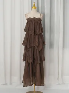 Elegant brown tiered maxi dress with delicate lace trim and thin straps