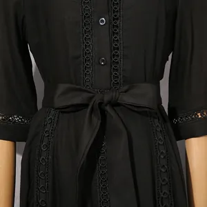 Detailed view of black retro dress showing hollow-out lace and waist-slimming bow belt