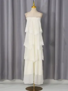 Sweet white tiered long dress with lace trim and spaghetti straps on a mannequin