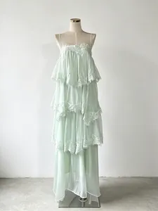 Elegant mint green tiered spaghetti strap maxi dress with delicate lace trim detail
