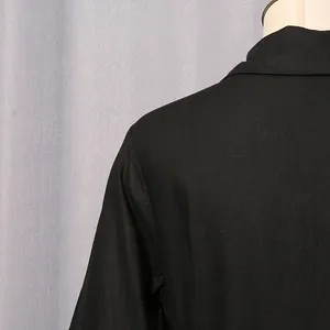 Detailed macro view of the shoulder and collar area on a black French retro style dress