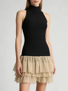 Elegant two-tone mini dress featuring a black sleeveless mock neck and ruffled beige skirt