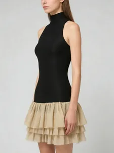 Elegant sleeveless high neck mini dress with black top and beige ruffled skirt.
