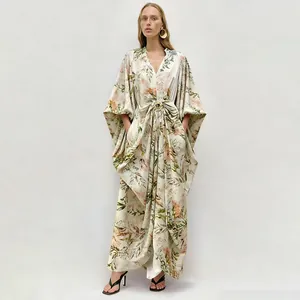 Detail of floral print maxi dress featuring elegant V-neck and metal buckle waist.