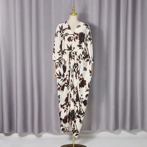 Close-up of a loose floral printed dress with V-neck and metal buckle detail.