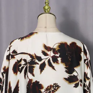 Detailed view of back neckline on a white loose dress with brown floral print pattern